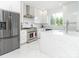 Modern white kitchen with stainless steel appliances and marble countertops at 323 Atherton St, Charlotte, NC 28203