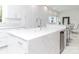 Modern white kitchen with marble countertops and stainless steel appliances at 323 Atherton St, Charlotte, NC 28203