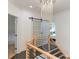 Elegant staircase with a modern chandelier and a barn door at 323 Atherton St, Charlotte, NC 28203