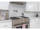 Modern kitchen with stainless steel range and microwave, white cabinets at 323 Atherton St, Charlotte, NC 28203