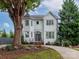 Two-story house with white siding, a dark gray door, and a landscaped yard at 323 Atherton St, Charlotte, NC 28203