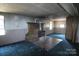 Living room with a stone fireplace and worn carpet at 2818 Rufus Ratchford Rd, Gastonia, NC 28056