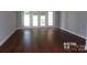 Bright living room with hardwood floors and French doors at 7118 Quail Meadow Ln, Charlotte, NC 28210