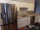 Stainless steel appliances and granite countertops in this updated kitchen at 7118 Quail Meadow Ln, Charlotte, NC 28210