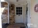White front door and stone entryway at 7118 Quail Meadow Ln, Charlotte, NC 28210