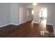 Living room with hardwood floors and neutral walls at 7118 Quail Meadow Ln, Charlotte, NC 28210