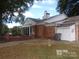 Brick building with patio and large windows at 7118 Quail Meadow Ln, Charlotte, NC 28210