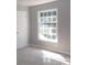 Well-lit bedroom featuring a large window and carpet flooring at 7118 Quail Meadow Ln, Charlotte, NC 28210