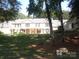 Two-story home with stone accents and a large lawn at 7118 Quail Meadow Ln, Charlotte, NC 28210