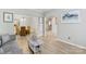 Living room with hardwood floors, neutral color scheme, and access to dining area at 1229 Brecken Ct, Kannapolis, NC 28081