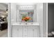 Double vanity bathroom with white cabinets and a view of the bedroom at 1229 Brecken Ct, Kannapolis, NC 28081