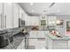 Modern kitchen with white cabinets, granite island, and stainless steel appliances at 1229 Brecken Ct, Kannapolis, NC 28081