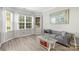 Living room features hardwood floors, large windows, and comfortable seating at 1229 Brecken Ct, Kannapolis, NC 28081