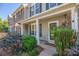 Townhome entrance with porch, landscaping, and doormat at 12136 Cane Branch Way, Huntersville, NC 28078