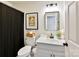 Clean bathroom boasts white vanity and black accents at 700 Cove Rd, Gastonia, NC 28052