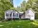 Beige house exterior with a two-car garage and a spacious lawn at 700 Cove Rd, Gastonia, NC 28052