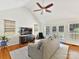 Living room with hardwood floors, a ceiling fan, and access to a deck at 700 Cove Rd, Gastonia, NC 28052