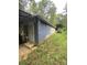Side view of a block building with a covered entryway and a tractor nearby at 6134 Shirley Rd, Fort Lawn, SC 29714