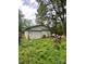 Detached garage with a white door and surrounded by greenery at 6134 Shirley Rd, Fort Lawn, SC 29714