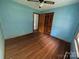 Light blue bedroom with wood flooring and a ceiling fan at 614 3Rd Street Sw Pl, Conover, NC 28613