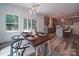 Dining area with a farmhouse-style table, kitchen access, and natural light at 1136 Forest Dr, Marshville, NC 28103