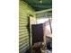 Cluttered porch with damaged door and needs significant cleanup at 215 S Ervin Ave, Newton, NC 28658