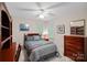 Well-lit bedroom with wooden furniture and a desk at 8907 Pointview Pl, Charlotte, NC 28269