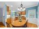 Bright breakfast nook with hardwood floors and built-in shelving at 8907 Pointview Pl, Charlotte, NC 28269