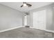 Gray walls and ceiling fan in this spacious bedroom at 5428 Alpine Ln, Charlotte, NC 28269