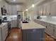 Modern kitchen featuring a large island, stainless steel appliances, and hardwood floors at 7550 Barrier Georgeville Rd, Concord, NC 28025