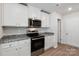 Modern kitchen with white cabinets and granite countertops at 146 Adams Tree Way, Troutman, NC 28166