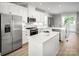 Modern kitchen featuring white cabinets, a large island, and stainless steel appliances at 2829 Statesville Ave, Charlotte, NC 28206