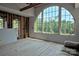 Living area under construction featuring a large arched window with woodland views at 8693 Gilead Rd, Huntersville, NC 28078