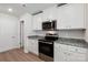 Modern kitchen with white cabinets and granite countertops at 217 Colonial Reserve Ave, Troutman, NC 28166