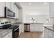 Modern kitchen with island, stainless steel appliances, and granite countertops at 217 Colonial Reserve Ave, Troutman, NC 28166