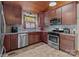 Modern kitchen with stainless steel appliances and wood cabinets at 746 Springwood Dr # 14&15, Mount Gilead, NC 27306