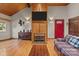 Living room with wood-paneled walls, fireplace, and hardwood floors at 746 Springwood Dr # 14&15, Mount Gilead, NC 27306