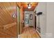 Long hallway with wood walls and floors, leading to bathroom and bedrooms at 746 Springwood Dr # 14&15, Mount Gilead, NC 27306