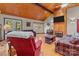 Cozy living room features wood-paneled walls, a fireplace, and ample seating at 746 Springwood Dr # 14&15, Mount Gilead, NC 27306