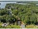 Aerial view of house on wooded lot with lake access at 746 Springwood Dr # 14&15, Mount Gilead, NC 27306