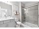 Bathroom with a walk-in shower, grey tile, and modern vanity at 6747 Baker Creek Ave, Indian Land, SC 29707