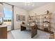 Home office with wood desk, built-in shelving, and natural light at 6747 Baker Creek Ave, Indian Land, SC 29707