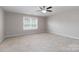 Large bedroom with ceiling fan and window at 2465 Palmdale Walk Dr, Fort Mill, SC 29708
