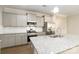 Modern kitchen featuring granite countertops, stainless steel appliances, and gray cabinets at 2465 Palmdale Walk Dr, Fort Mill, SC 29708