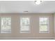 Bright bedroom featuring three windows with blinds at 2465 Palmdale Walk Dr, Fort Mill, SC 29708