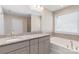 Double vanity bathroom with granite countertops, soaking tub, and walk-in shower at 2465 Palmdale Walk Dr, Fort Mill, SC 29708