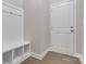 White entryway bench with storage and coat hooks at 2465 Palmdale Walk Dr, Fort Mill, SC 29708