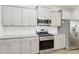 Modern kitchen with stainless steel appliances and gray cabinets at 2465 Palmdale Walk Dr, Fort Mill, SC 29708