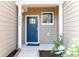 Inviting front entry with blue door and landscaping at 2465 Palmdale Walk Dr, Fort Mill, SC 29708