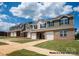 Townhouses with brick and siding, two-car garages, and landscaped lawns at 5332 Cherrie Kate Ct # 1703, Stanley, NC 28164
